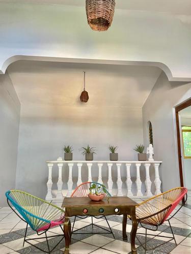 a dining room with a table and chairs at Hotel Casa Verde in Troncones