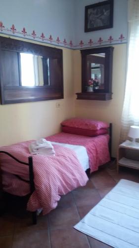 a bedroom with two beds with pink sheets at Villa Fiorita in Monfalcone