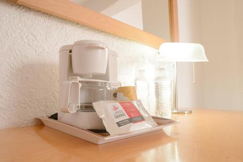 a coffee maker sitting on a counter next to a lamp at HOTEL DON MIGUEl in Tapachula