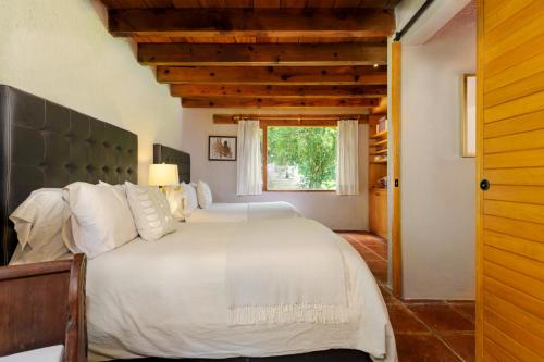 Katil atau katil-katil dalam bilik di Casas Abi, A Tranquil Retreat Surrounded by nature