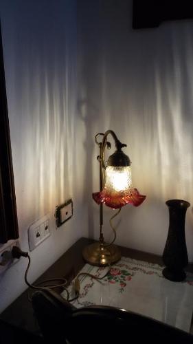 a lamp sitting on top of a table in a room at Villa Fiorita in Monfalcone
