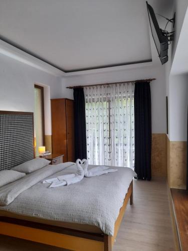 a bedroom with a large bed and a window at Montana in Suceviţa