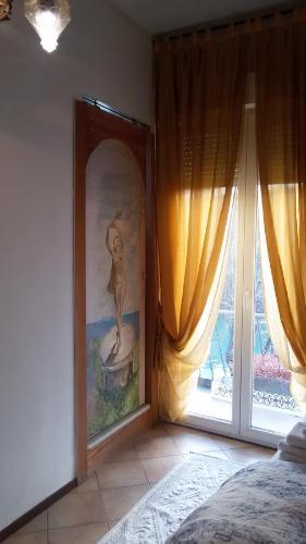 a bedroom with a picture of a woman on the wall at Villa Fiorita in Monfalcone