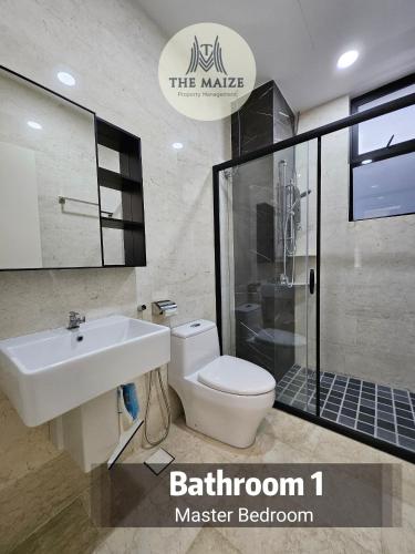 a bathroom with a toilet and a sink and a shower at The Cove Ipoh - Blissful Abodes in Tambun