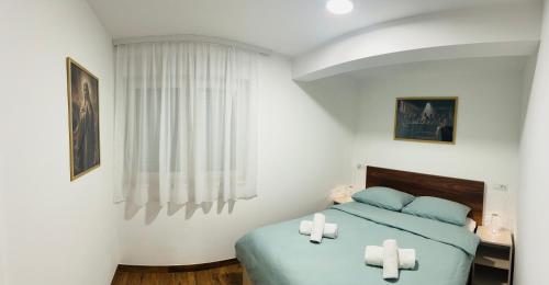 a bedroom with a bed with two crosses on it at Quattro Apartment in Međugorje