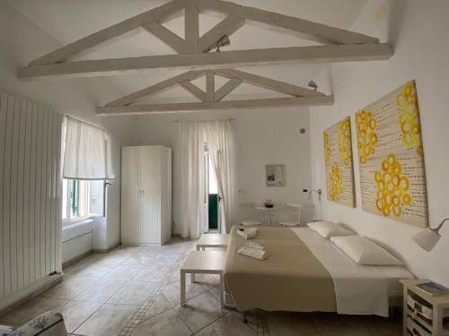 a bedroom with a bed and a table in it at La Torre e il Mare Rooms by STHEY in Monopoli