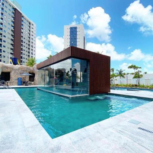 a swimming pool with a building in the middle of it at Salinas Premium 2 quartos C10 in Salinópolis