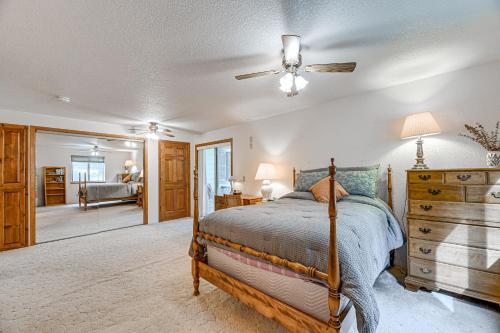 a bedroom with a bed and a ceiling fan at Close to Wine Trail Home with Deck Near Applegate in Grants Pass