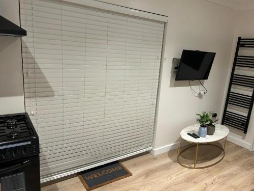 a kitchen with a large window with a blind at Orbit guest house in Horne