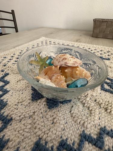 a glass bowl filled with shells on a table at Il Sole Verde in Marrùbiu