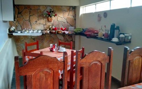 a dining room with a table and four chairs at Pousada Presidente in Diamantina