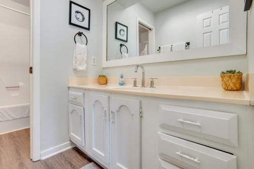 a white bathroom with a sink and a mirror at St Helena Island Retreat with Deck Walk to Beach in Oceanmarsh Subdivision