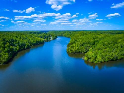 an aerial view of a river with green forests at Luxurious Lake Getaway in Winchester