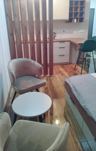 a room with a bed and a chair and a table at Twins Apartment in Strumica