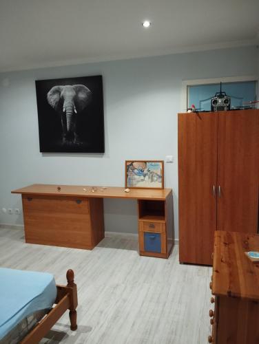 a bedroom with a desk with a picture of an elephant at Casa da aldeia in Amor