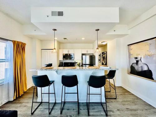 a kitchen with a bar with chairs around it at City View Location For Entertainment And Sports in Indianapolis