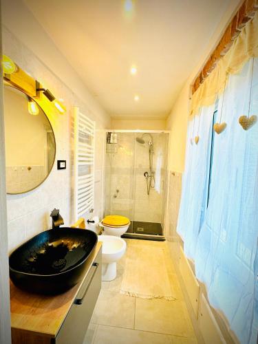a bathroom with a sink and a toilet and a tub at Casa Olive 53 Monte in La Spezia