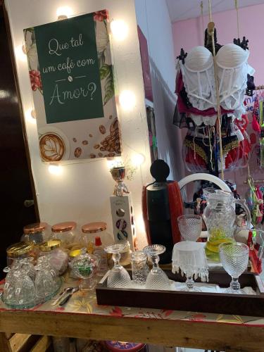 a table with glasses and other items on it at Hostel Casa Jambo Guaruja in Guarujá