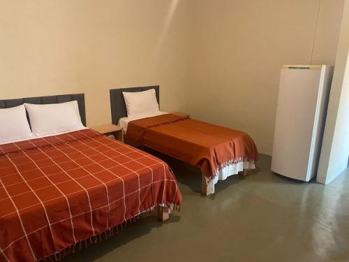 Postel nebo postele na pokoji v ubytování Pousada Recanto Das Gerais