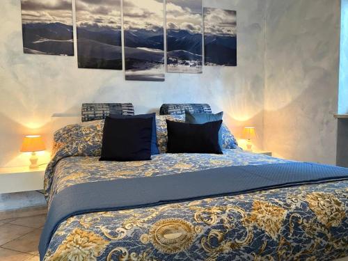 a bedroom with a king sized bed with blue sheets at Stillness Valley - La Casa nella Valle della Quiete in San Mauro Torinese