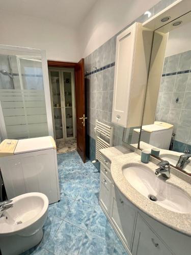 a bathroom with two sinks and a toilet at Daddy's house - maximum car length allowed 420cm in Genova