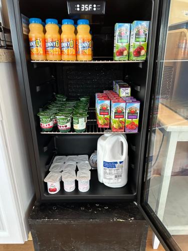 a refrigerator filled with lots of drinks and milk at Yardarm Motel in Searsport