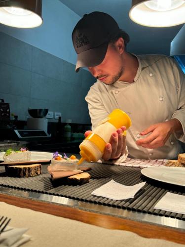 a man is preparing food in a kitchen at Agriturismo Millennial in Quarrata