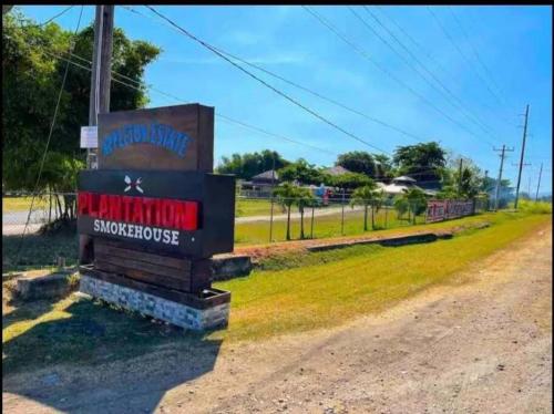 a sign on the side of a dirt road at KK'S Elite Escape with private beach in Richmond