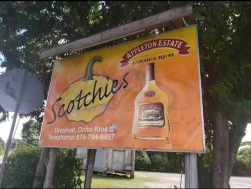 a sign for a restaurant with a bottle of spirits at KK'S Elite Escape with private beach in Richmond