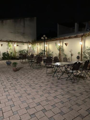 a group of tables and chairs in a courtyard at night at Leimen51 WG3 in Leimen