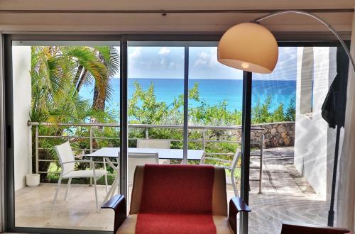 a living room with a view of the ocean at Beachfront Serenity in Cupecoy