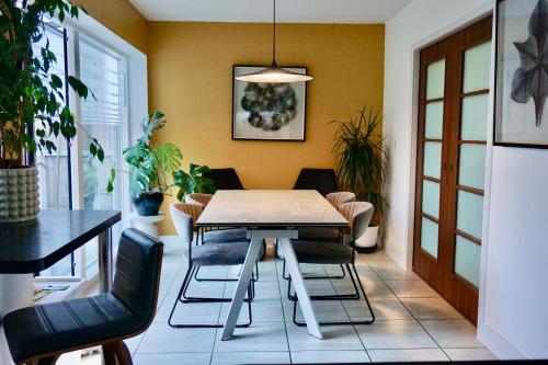 a dining room with a table and chairs at Manor Park View in Norwich