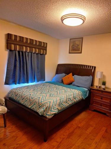 a bedroom with a bed with blue curtains at Mozzy-Love Room in Orlando