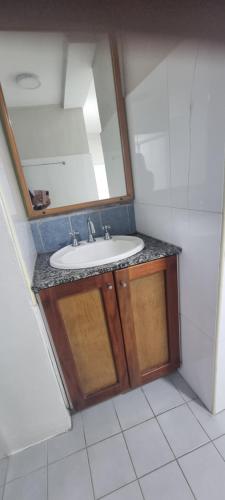 a bathroom with a sink and a mirror at The Cozy Escape in Samambula North