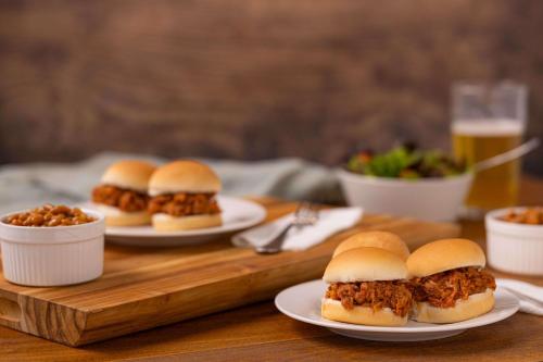 a group of sandwiches on plates on a wooden table at Drury Inn & Suites Paducah in Paducah