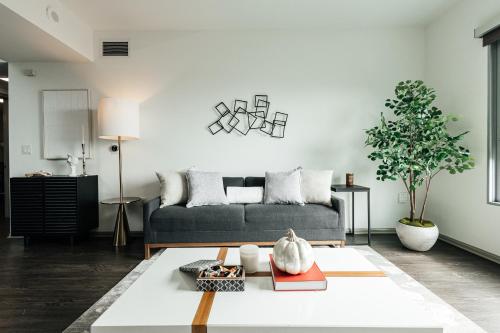 a living room with a couch and a table at Hollywood Designer Apartment in Los Angeles