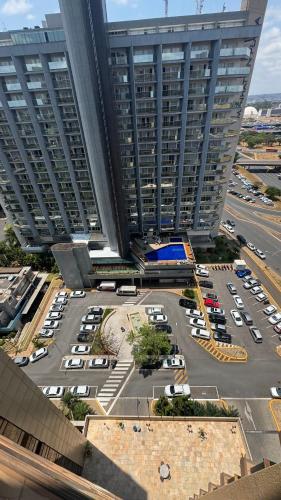 an aerial view of a parking lot in front of two tall buildings at MANHATTAN - JK APART Hotel in Brasilia