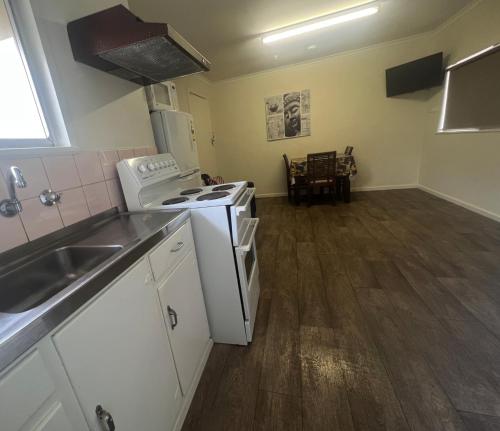 a kitchen with a stove top oven next to a sink at Whyalla Caravan And Tourist Park in Whyalla