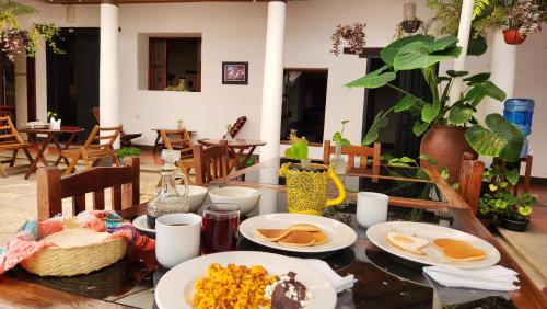 une table avec des assiettes de nourriture dessus dans l'établissement Arte Sano Hotel San Cristobal, à San Cristóbal de Las Casas