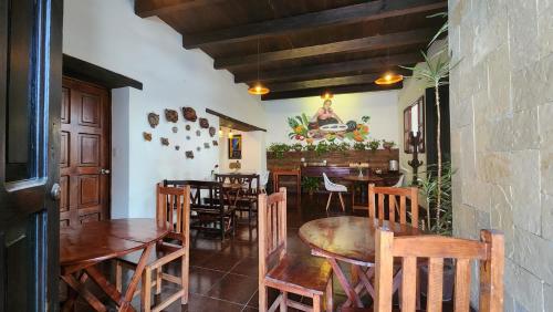 a dining room with wooden tables and chairs at Arte Sano Hotel San Cristobal in San Cristóbal de Las Casas