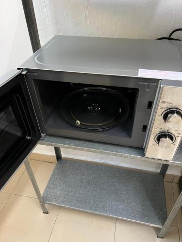 a microwave oven on a shelf in a kitchen at 7 STAY#2 - 1 Room for 3 Pax at Kuala Berang -Best Travelers Stay in Kuala Berang