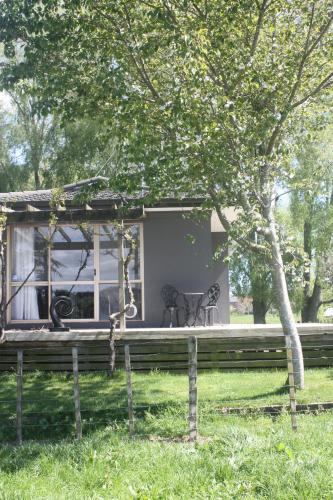 a house with a porch with a table and chairs at Willow's End in Hamurana