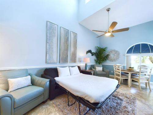 a living room with a couch and a table at Royal Mansions, Ocean View Penthouse Condo in Cape Canaveral