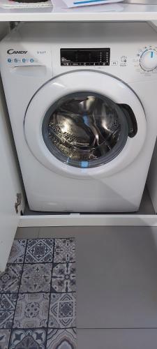 a white washing machine with its door open at Bellini's House in Montecatini Terme
