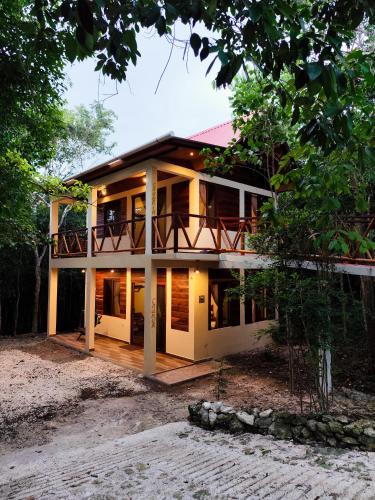a large house with a balcony on top of it at Eco Aldea kinich Ahau in Xpujil