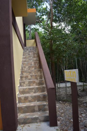 a staircase leading up to a building with a sign at Eco Aldea kinich Ahau in Xpujil