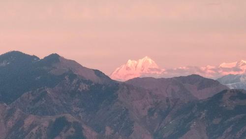 a snow covered mountain in the distance at Grand Kailash Khajjiar in Dalhousie