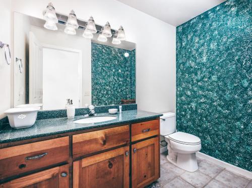 a bathroom with a sink and a toilet at Breathtaking view of the Hills with HotTub, Pool and Pool Table in Marble Mountain