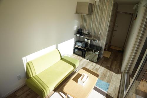 a living room with a couch and a table at Farm Stay Ezura Farm in Engaru