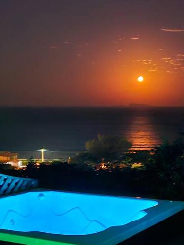 a view of the ocean at night with the sun at Nosso Mar in Florianópolis